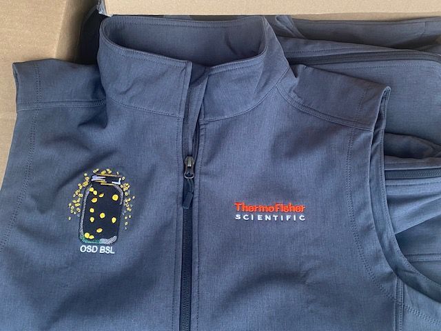 Photo from GMB's existing apparel gallery; shown for decoration and product planning, not current stock availability. Navy quarter-zip with embroidered Thermo Fisher branding for a coordinated staff apparel program