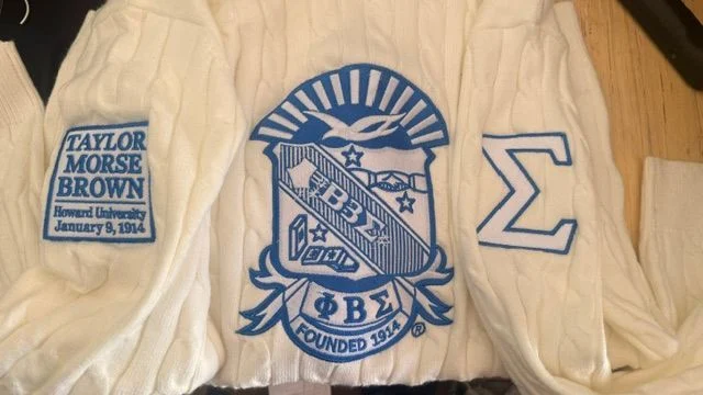 Blue Phi Beta Sigma embroidery on a cream garment